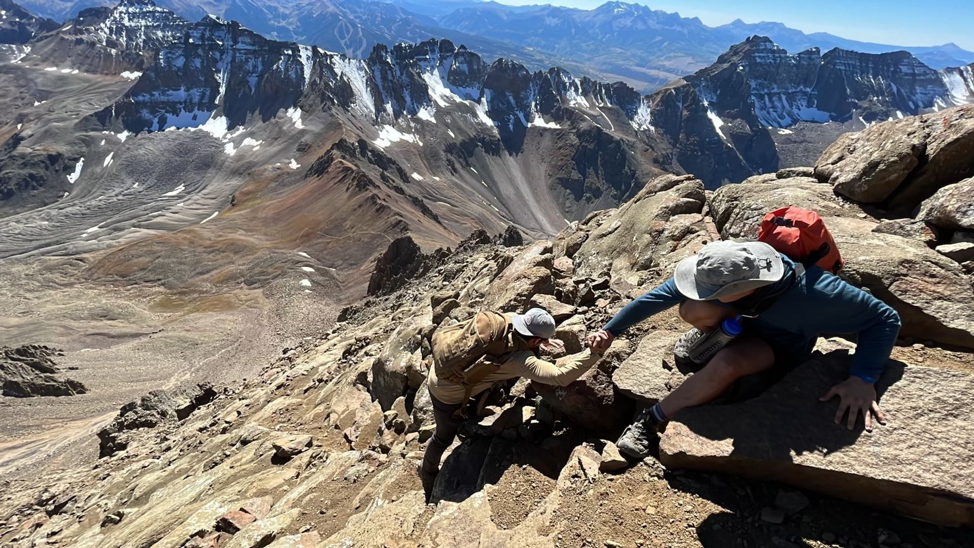 Isaac hoisting Anthony on mountain